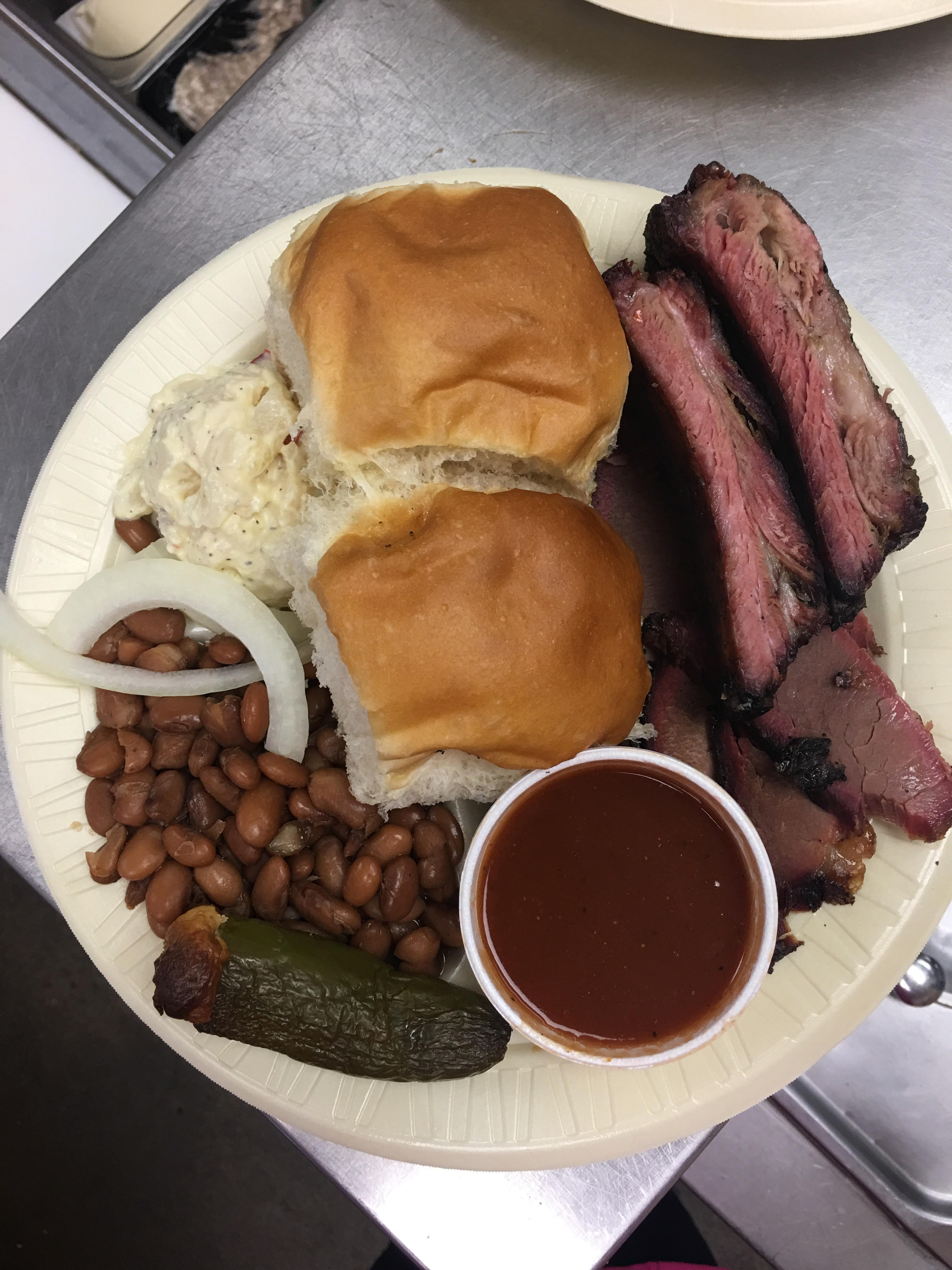 The Sticks BBQ — two-meat plate with sliced brisket, sausage, smoked jalapeños, and BBQ sauce, Brownwood TX