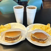 The Sticks BBQ — two burgers and fountain drinks on a table, Brownwood TX