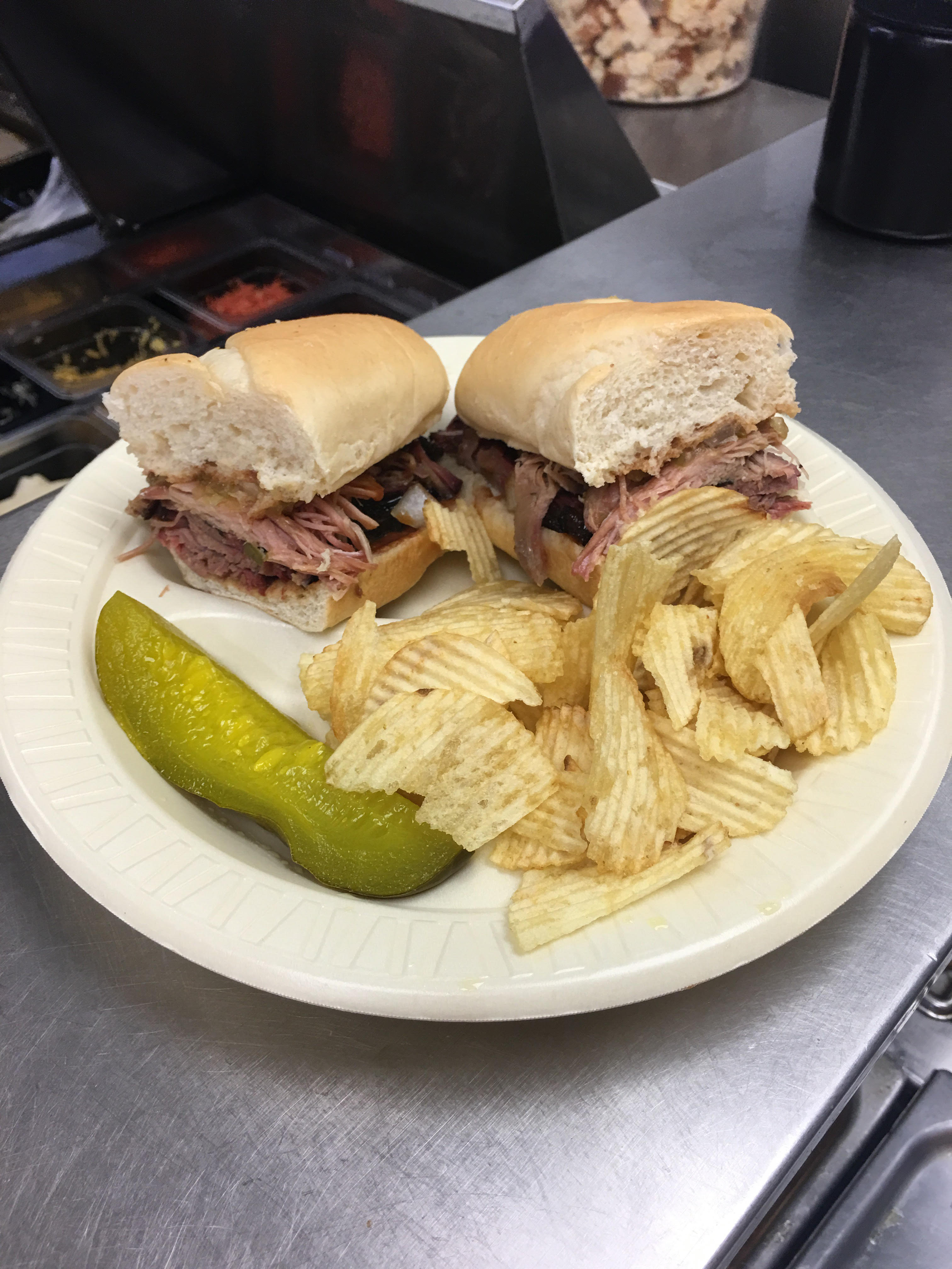 The Sticks BBQ — Combo Po Boy sandwich on a tray with chips and pickle, Brownwood TX