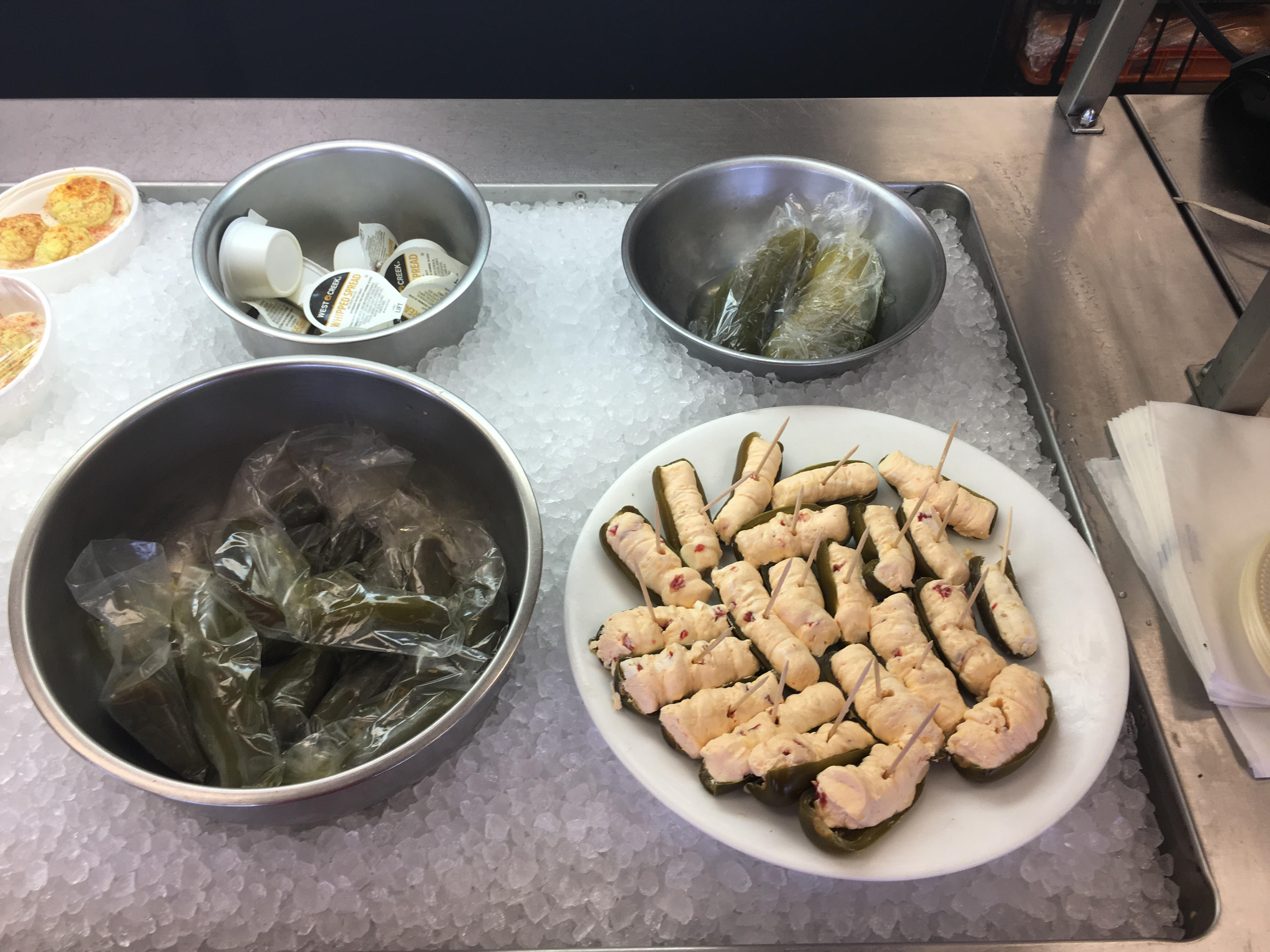 The Sticks BBQ — bacon-wrapped stuffed jalapeños, smoked jalapeños, and cream cheese cups on ice, Brownwood TX